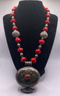 Antique Tibetan coral ghau pendant with a coral and silver necklace