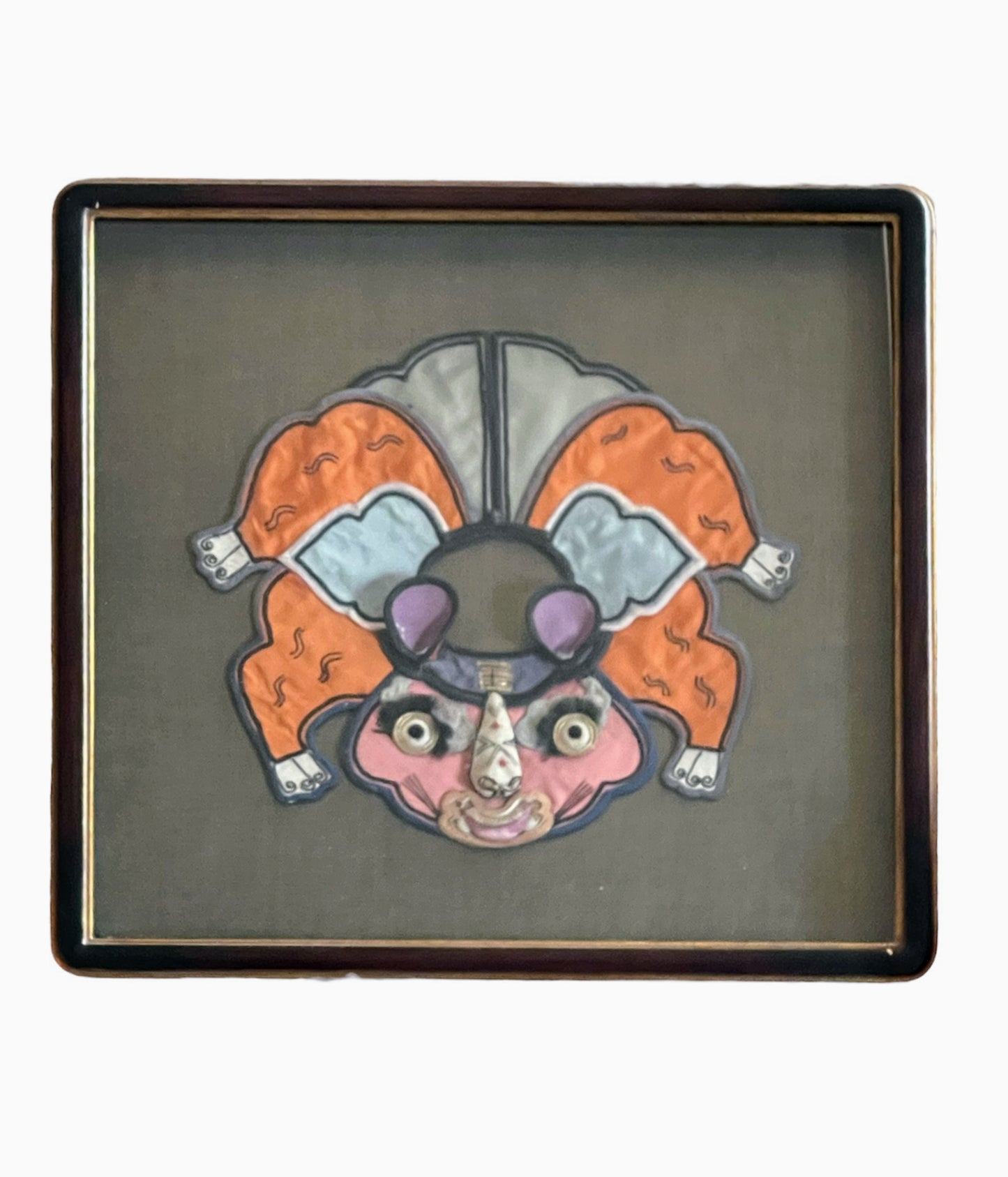 An antique childrens collar with an animal design in a box frame
