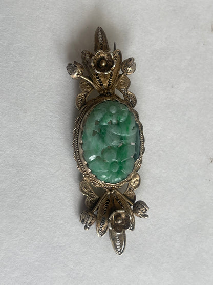 A vintage jade brooch In a gilded silver setting
