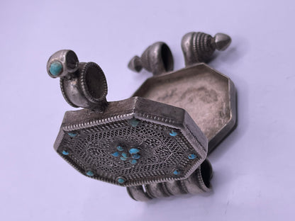An antique 19th C., few Tibetan silver ghau with silver filigree and turquoise.