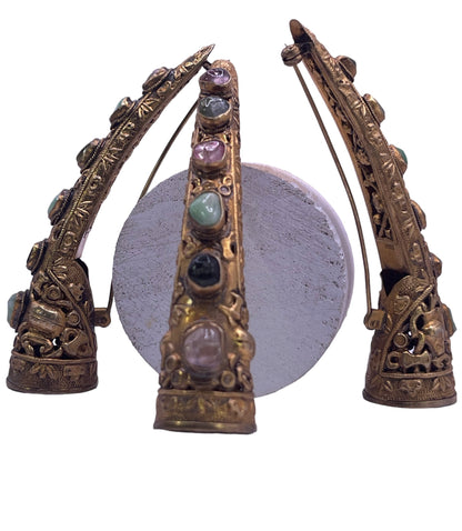 A set of three vintage gilded silver nail covers