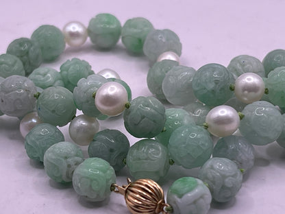 A necklace with vintage carved jade shou beads and pearls