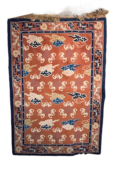 A mid 20th C. Peking rug with clouds and bats motifs
