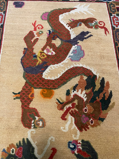 A vintage mid 20th c. Tibetan rug with dragons