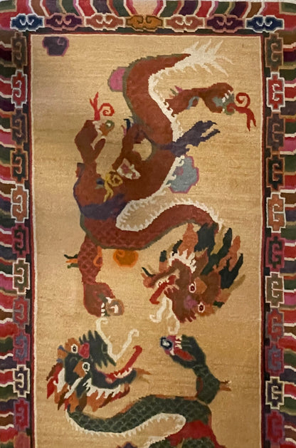 A vintage mid 20th c. Tibetan rug with dragons