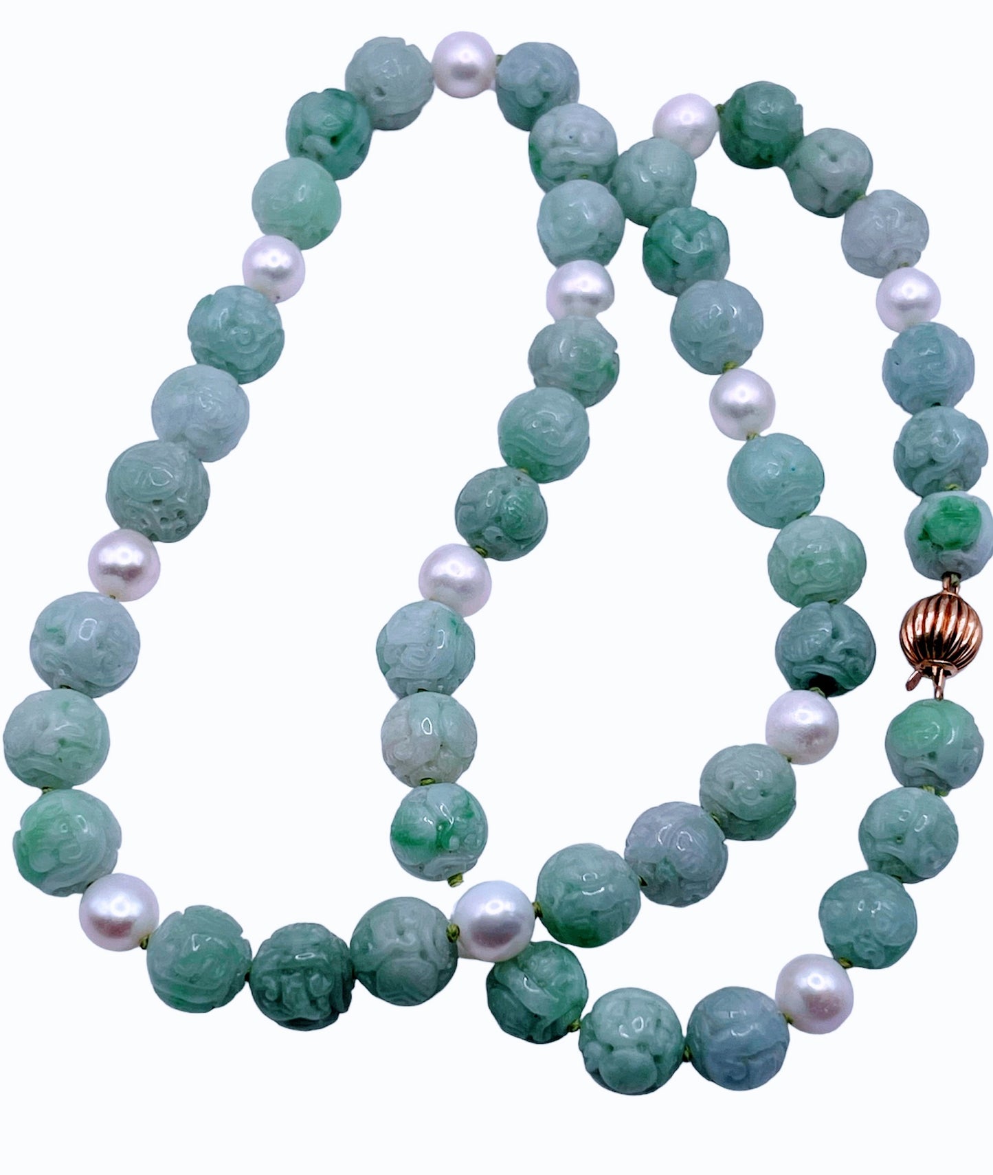 A necklace with vintage carved jade shou beads and pearls