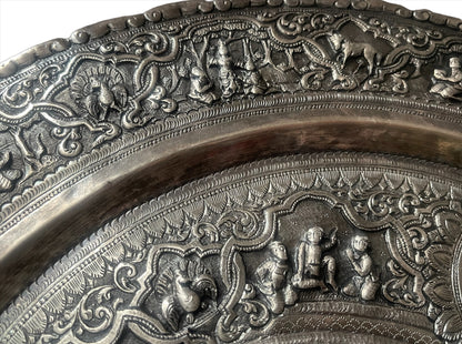 A Burmese antique elaborately carved circular tray and oval shaped jug with a pointed mug.
