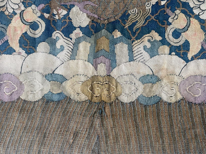 An antique framed Chinese silk kesi of a pair of dragons