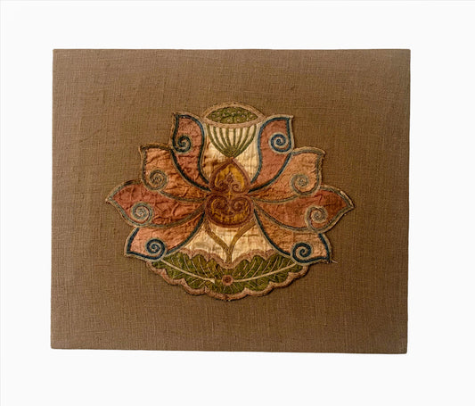 An antique lotus applique art mounted on a fabric frame