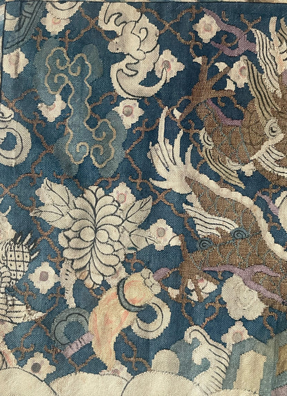 An antique framed Chinese silk kesi of a pair of dragons