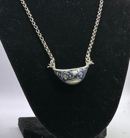 A vintage silver pendant and chain