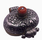 An antique silver and coral ghau amulet