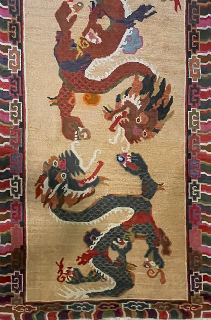 A vintage mid 20th c. Tibetan rug with dragons