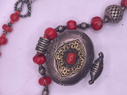 Antique Tibetan coral ghau pendant with a coral and silver necklace