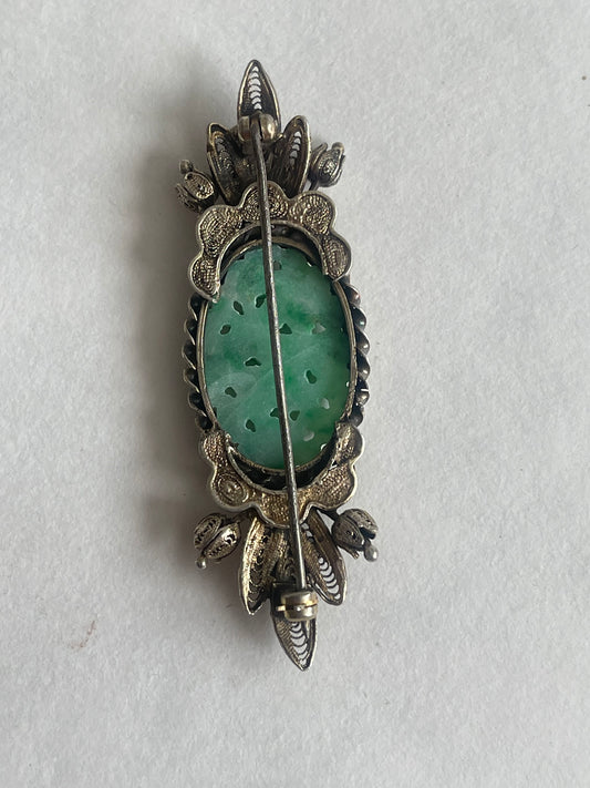 A vintage jade brooch In a gilded silver setting