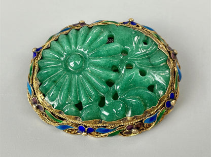 A vintage jade brooch in enameled gilt silver
