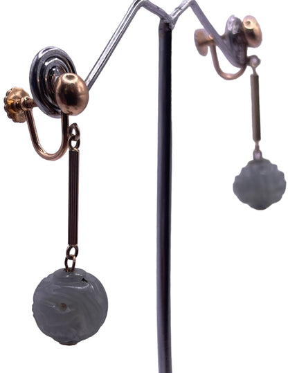 A pair of carved jade shou beads in a 14kt setting